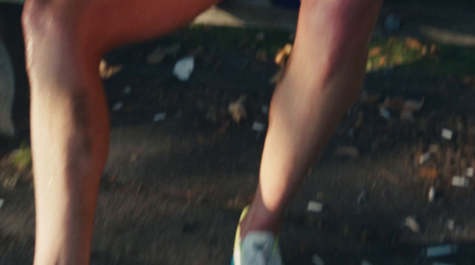 a close up of a person's legs as they ride a skateboard