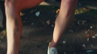 a close up of a person's legs as they ride a skateboard