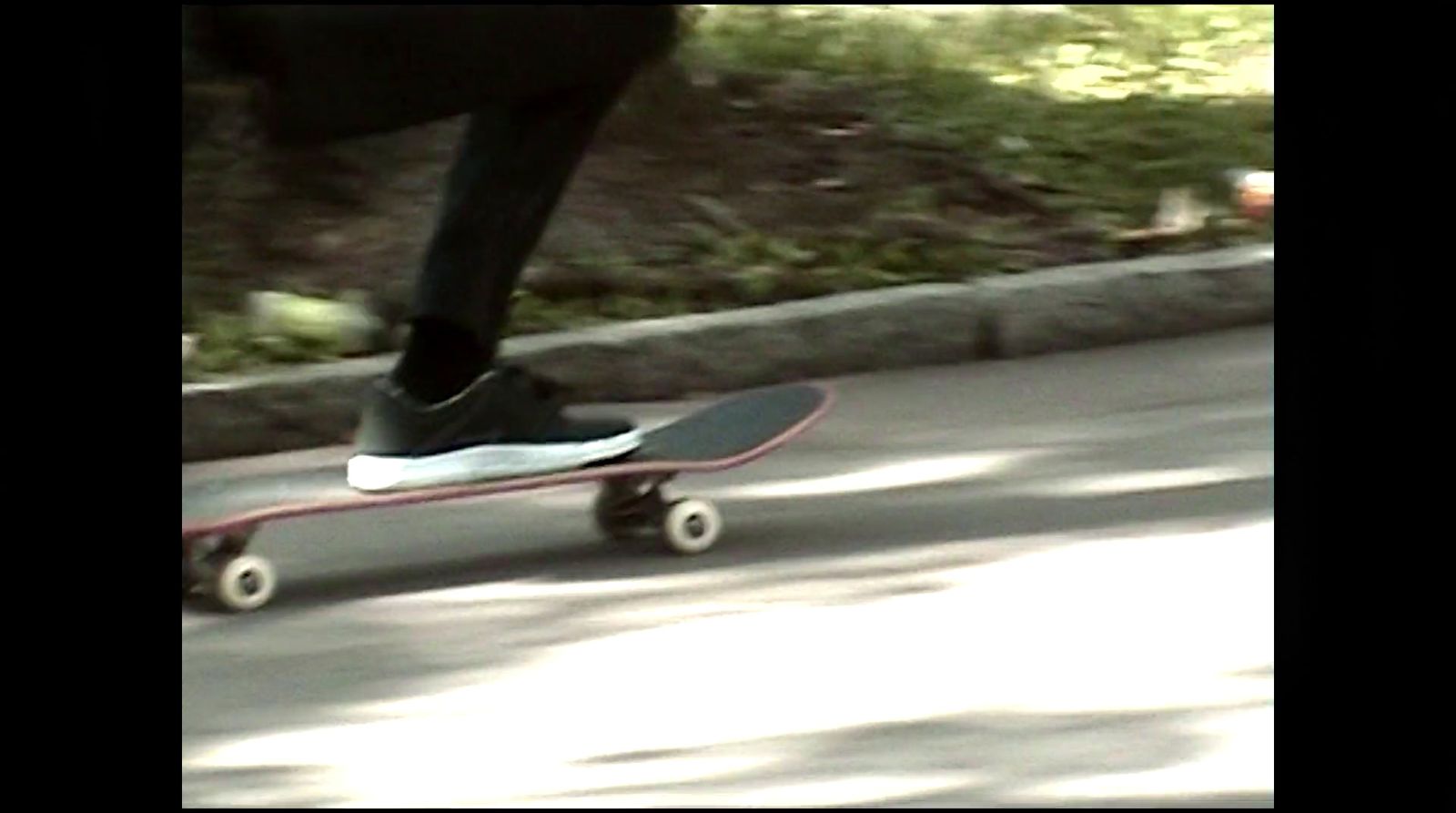 a person riding a skateboard down a street