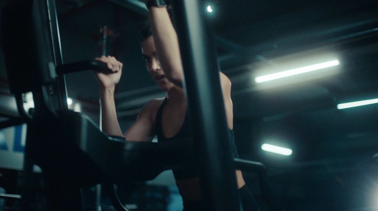 a woman working out with a barbell in a gym