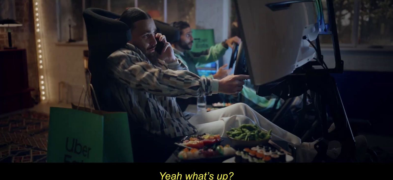 a man sitting in a chair talking on a cell phone