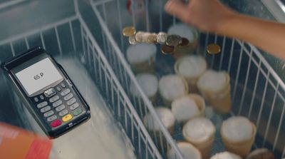 a calculator sitting on top of a counter filled with coins