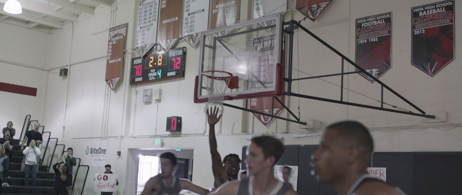 a group of young men playing a game of basketball