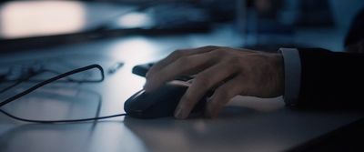 a person using a computer mouse on a desk