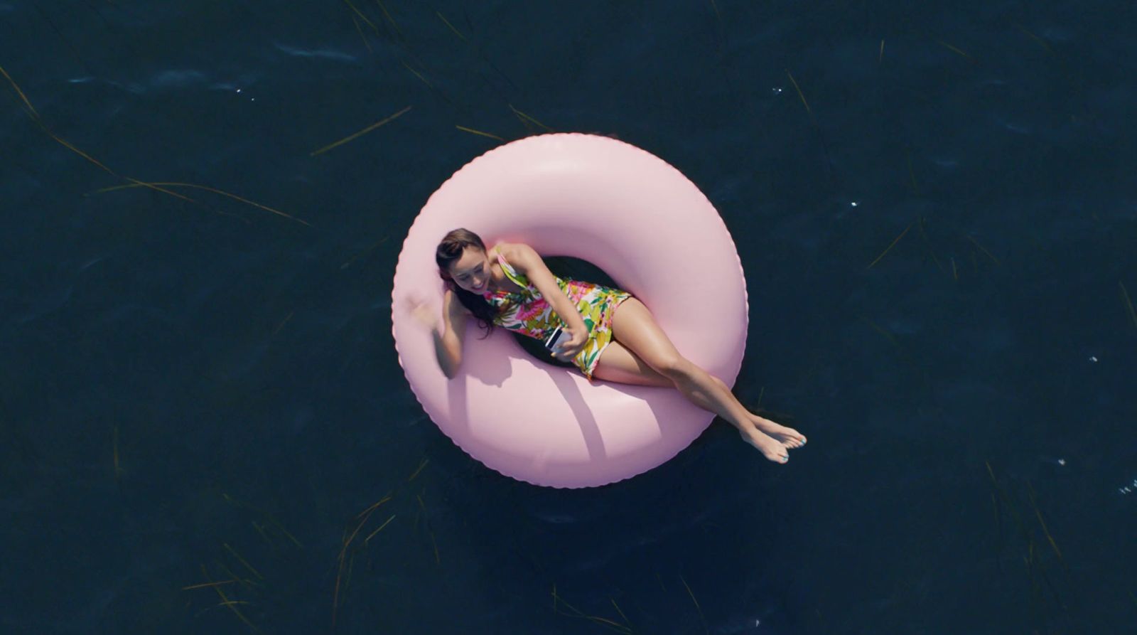 a woman laying on an inflatable raft in the water