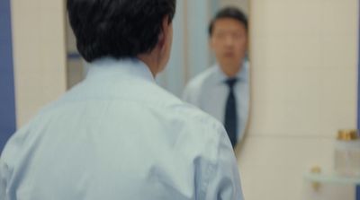 a man looking at himself in the mirror