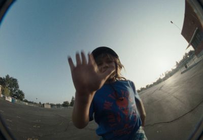 a young girl is skateboarding in a skate park