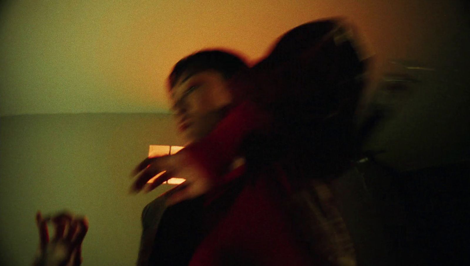 a blurry photo of a person holding a cell phone