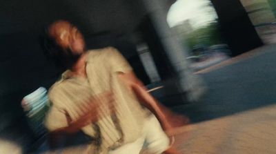 a man riding a skateboard down a street