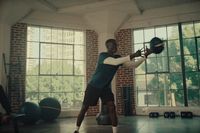 a man holding a hat in a gym