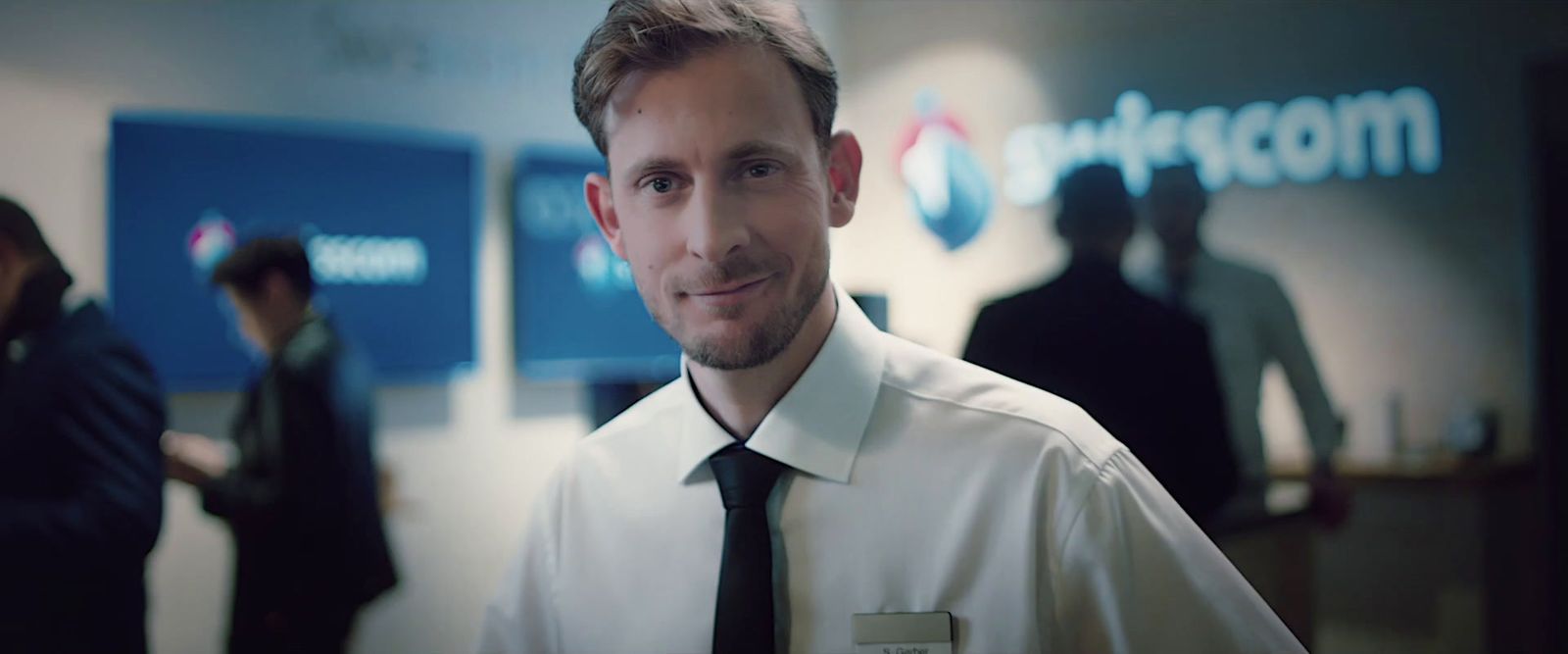 a man in a white shirt and black tie