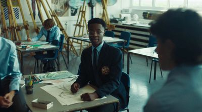 a man sitting at a desk in a classroom