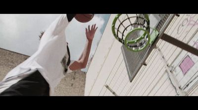 a man reaching up to grab a basketball