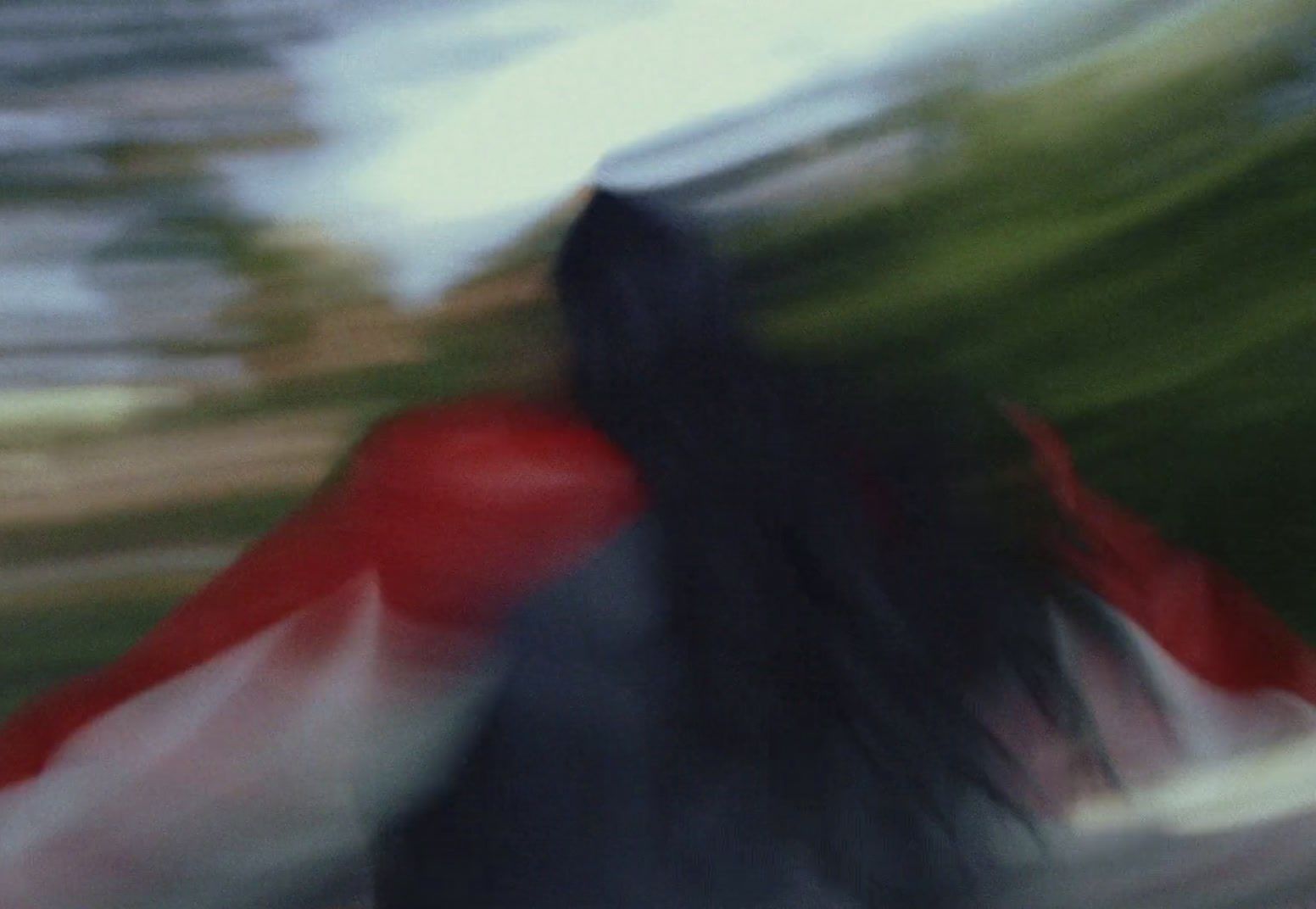 a blurry photo of a woman with long hair