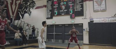 a group of young men playing a game of basketball