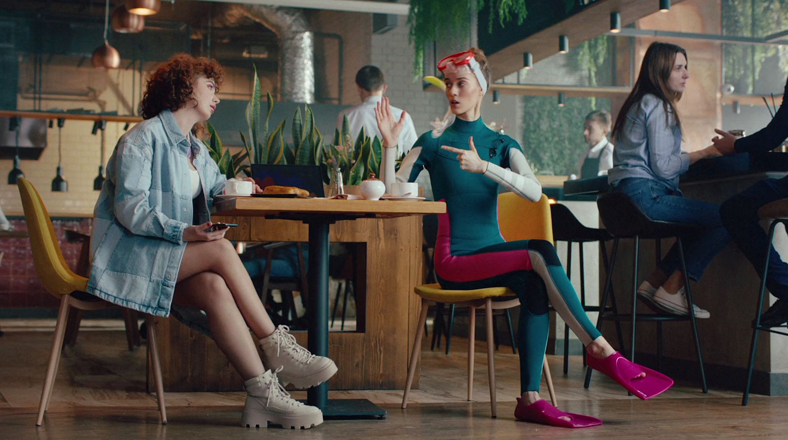 a group of women sitting around a table talking