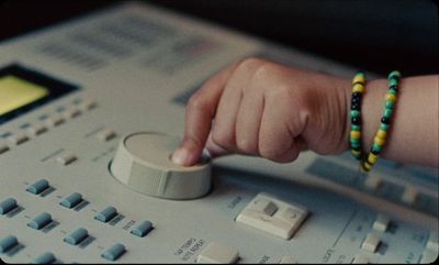 a person pressing buttons on a sound board