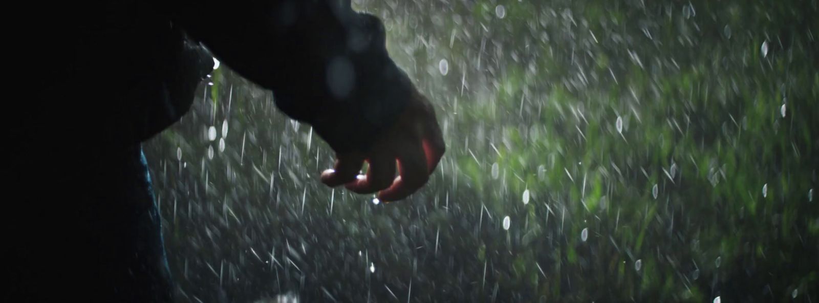 a person holding an umbrella in the rain