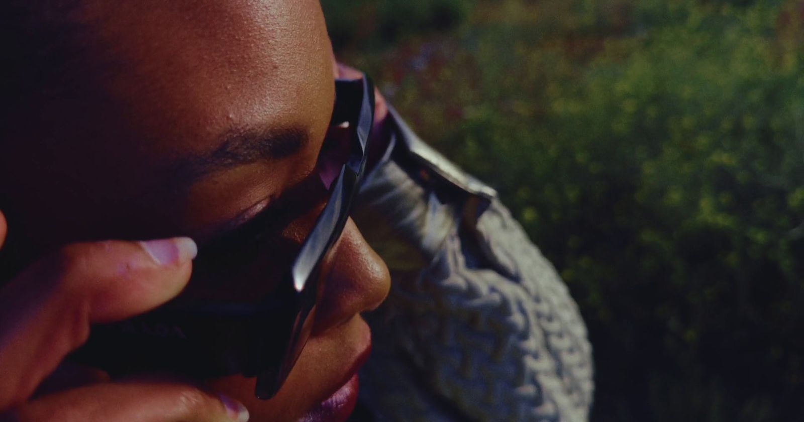 a man talking on a cell phone while holding a cell phone to his ear