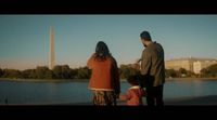 a group of people standing next to a body of water