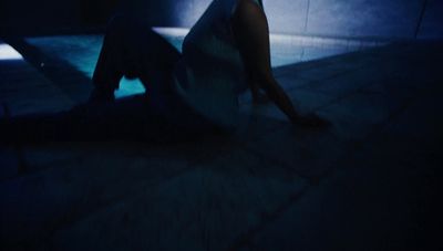 a person sitting on the ground in the dark