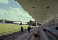 a blurry photo of people walking on a soccer field