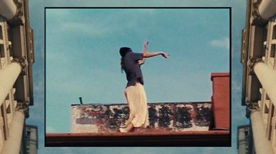 a woman standing on top of a building