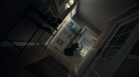 a blurry image of a person standing in a kitchen