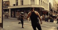 a group of people running down a street