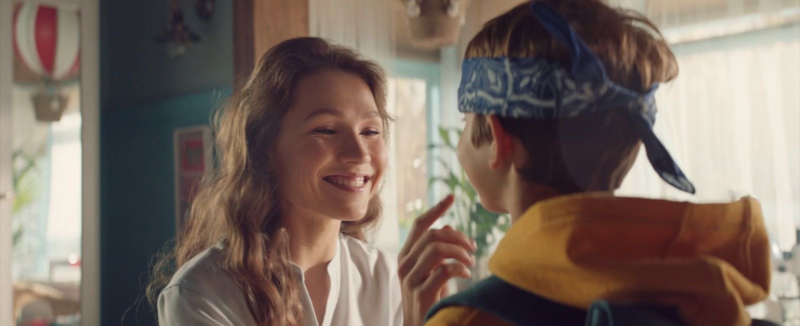 a young boy and a young girl standing in a kitchen