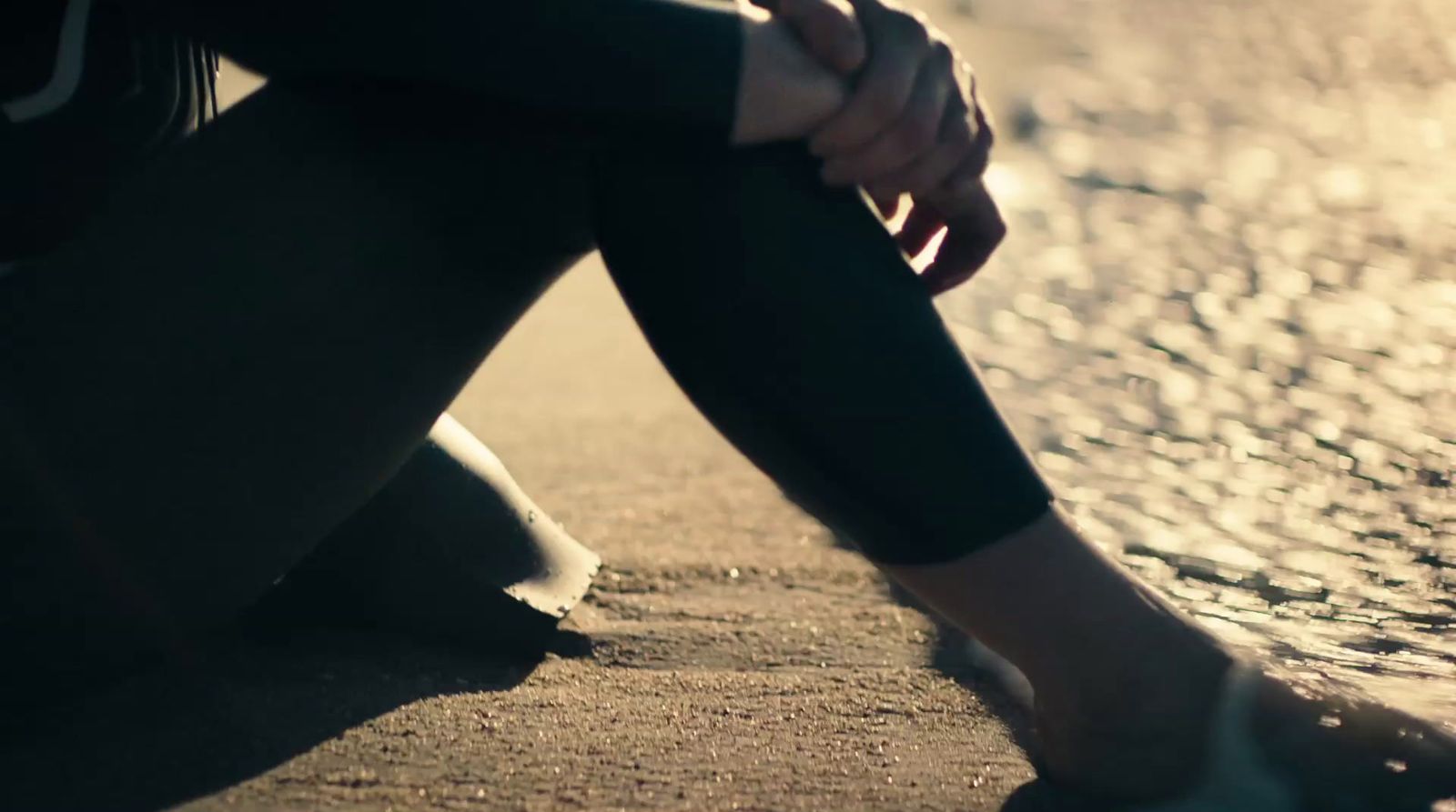 a person sitting on the ground with their feet up