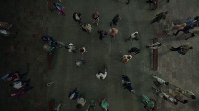 a group of people standing on a street next to each other