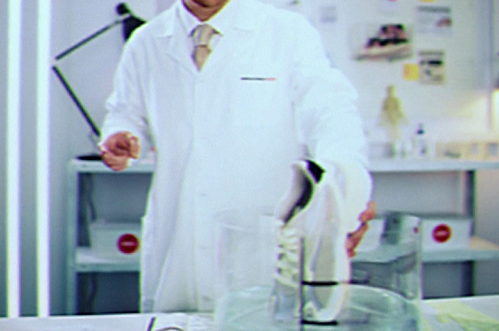 a man in a lab coat holding a beakle