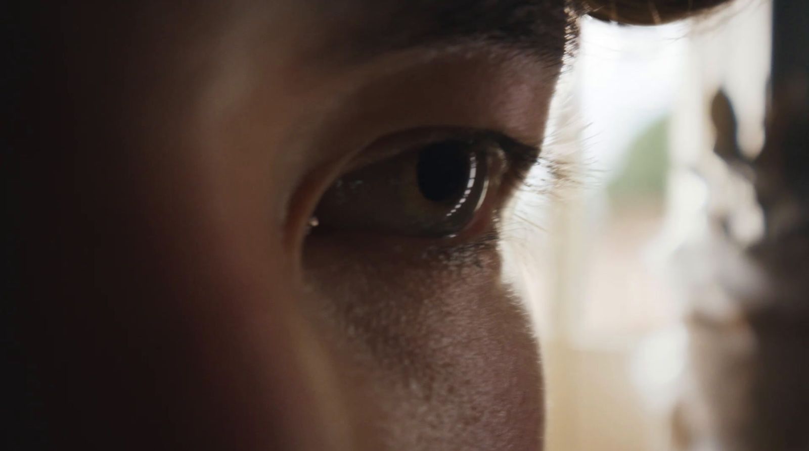 a close up of a person's eye with a blurry background