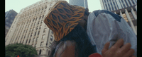 a woman with a tiger head covering her face