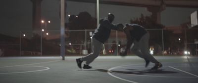 a couple of men playing a game of basketball