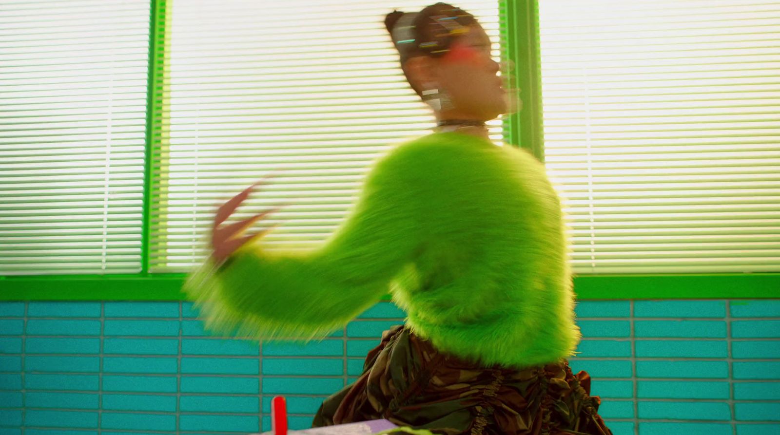 a woman in a green top is dancing