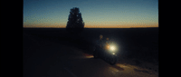 a car driving down a road at night