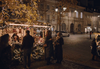 a group of people standing around a christmas tree