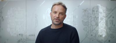 a man standing in front of a glass wall