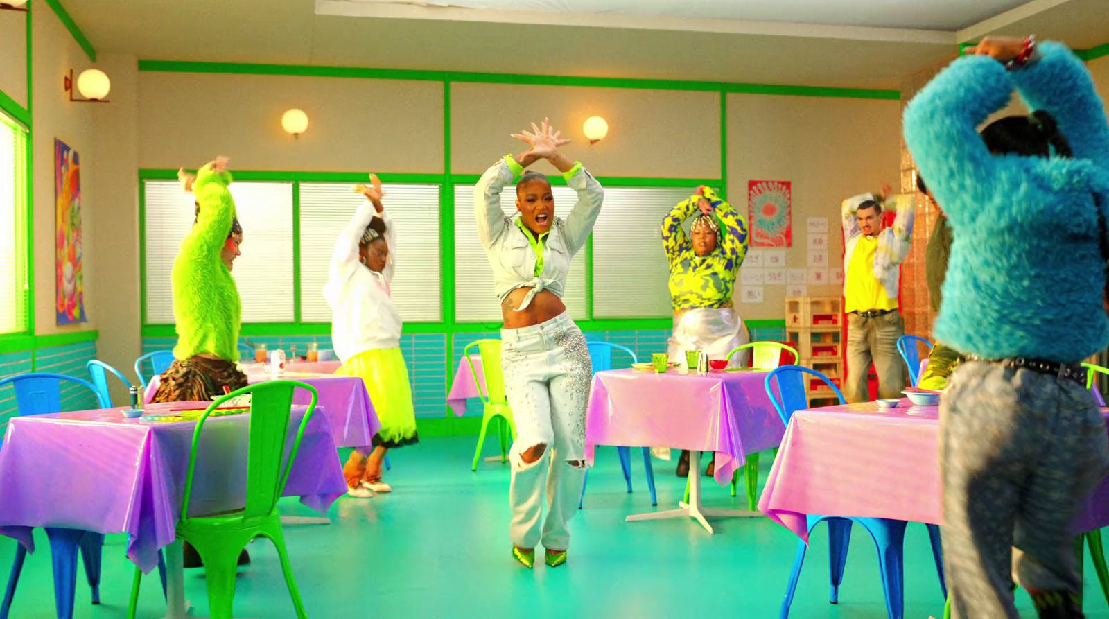 a group of people dancing in a brightly colored room