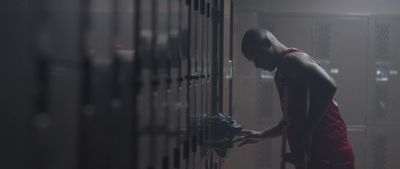 a man in a red robe is opening a locker