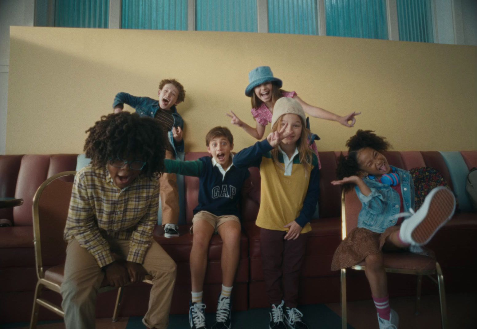 a group of children sitting on top of a couch