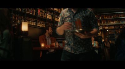 a man standing in front of a bar holding a cell phone