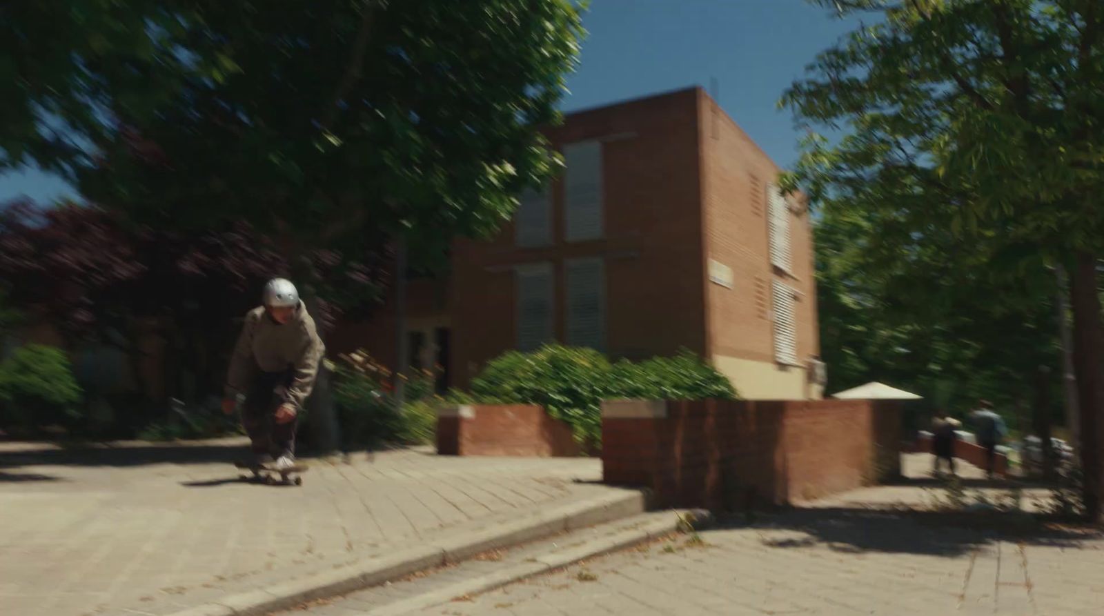 a man riding a skateboard down a sidewalk