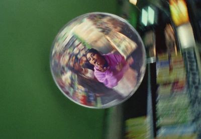 a person in a ball on a green wall