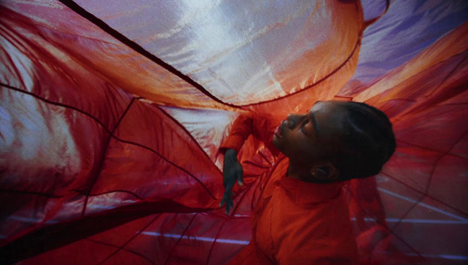 a little girl in a red dress with a red umbrella