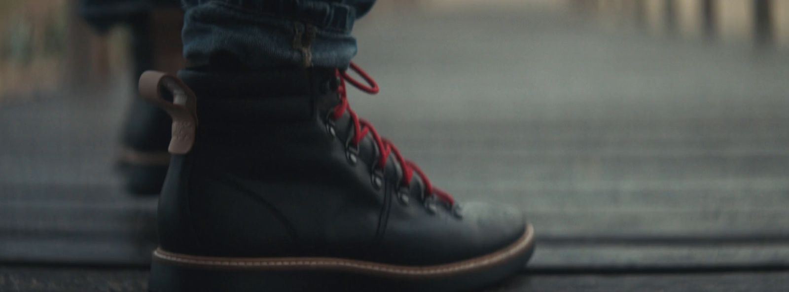 a close up of a person's shoes on a sidewalk