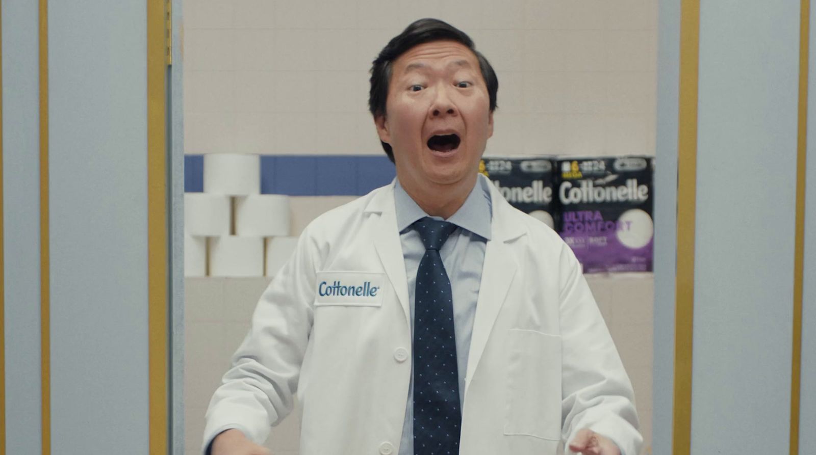 a man in a lab coat and tie making a surprised face