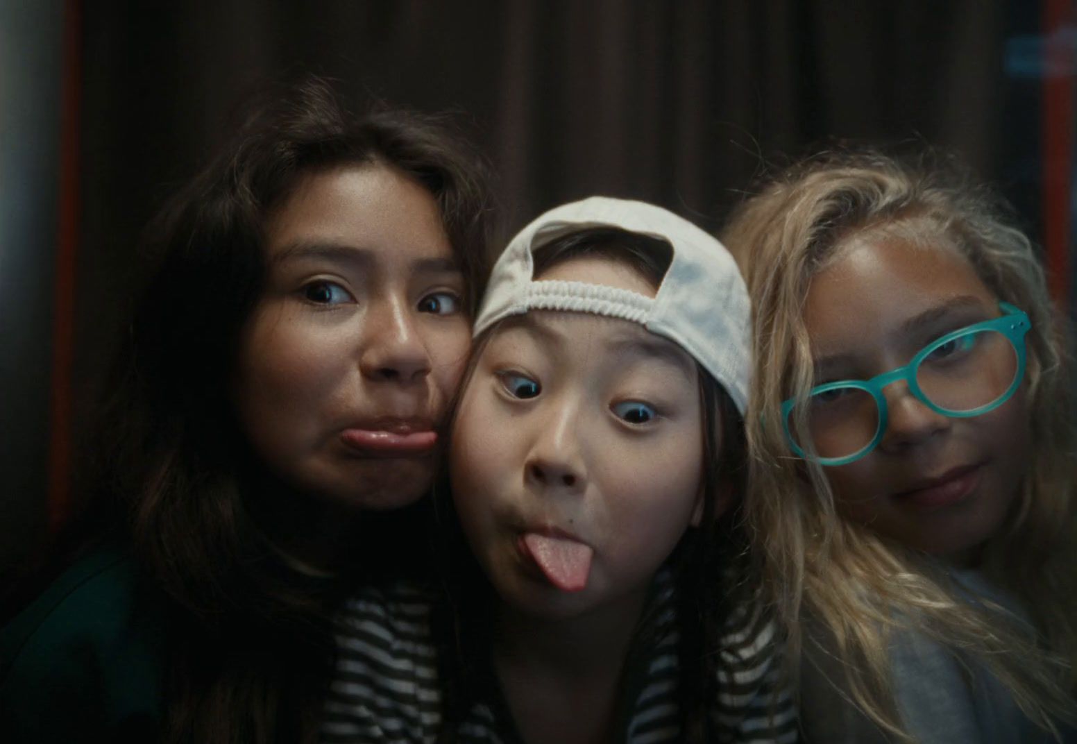 three girls with their mouths open and their faces covered